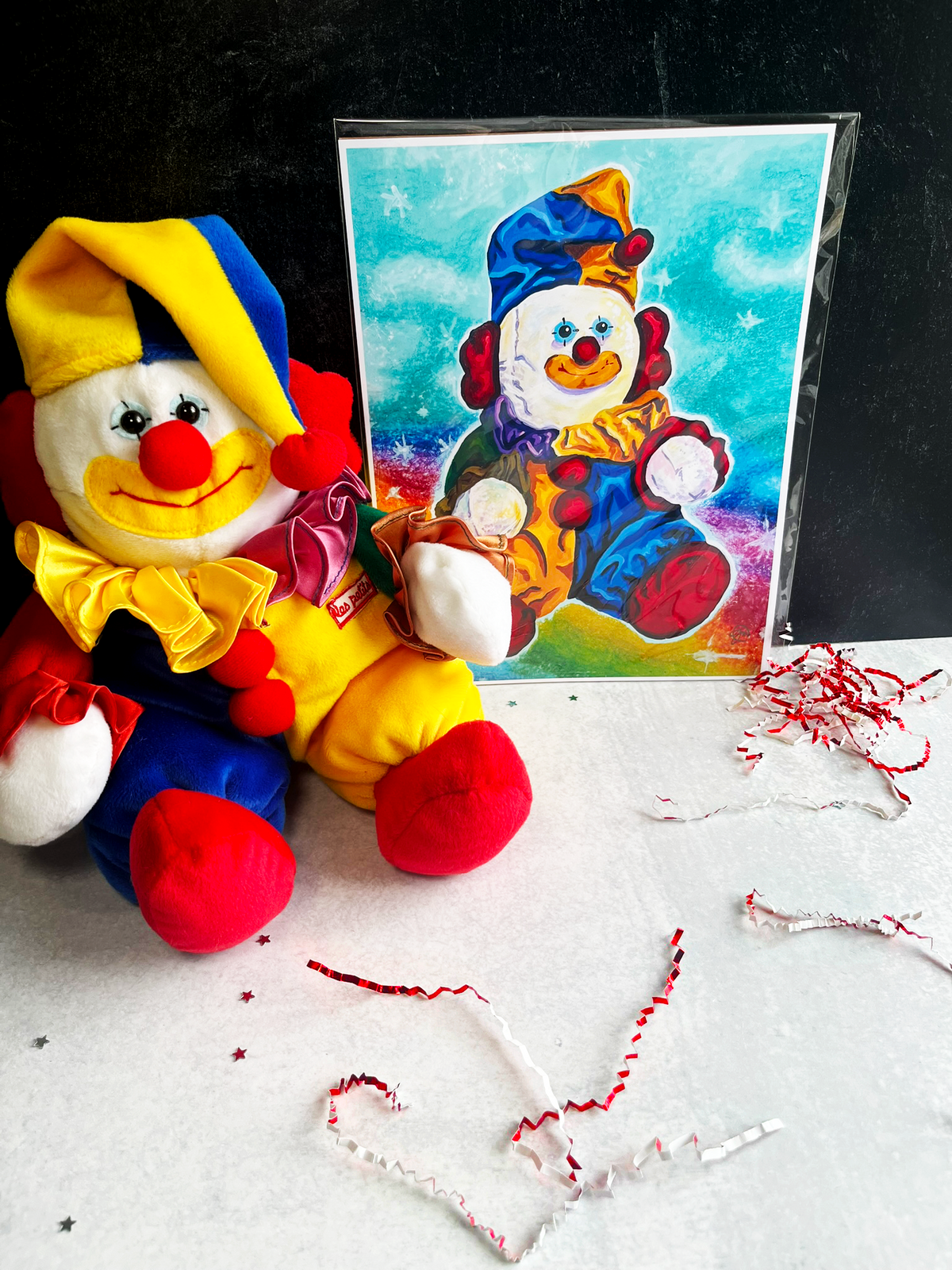 clown stuffed animal posing with print